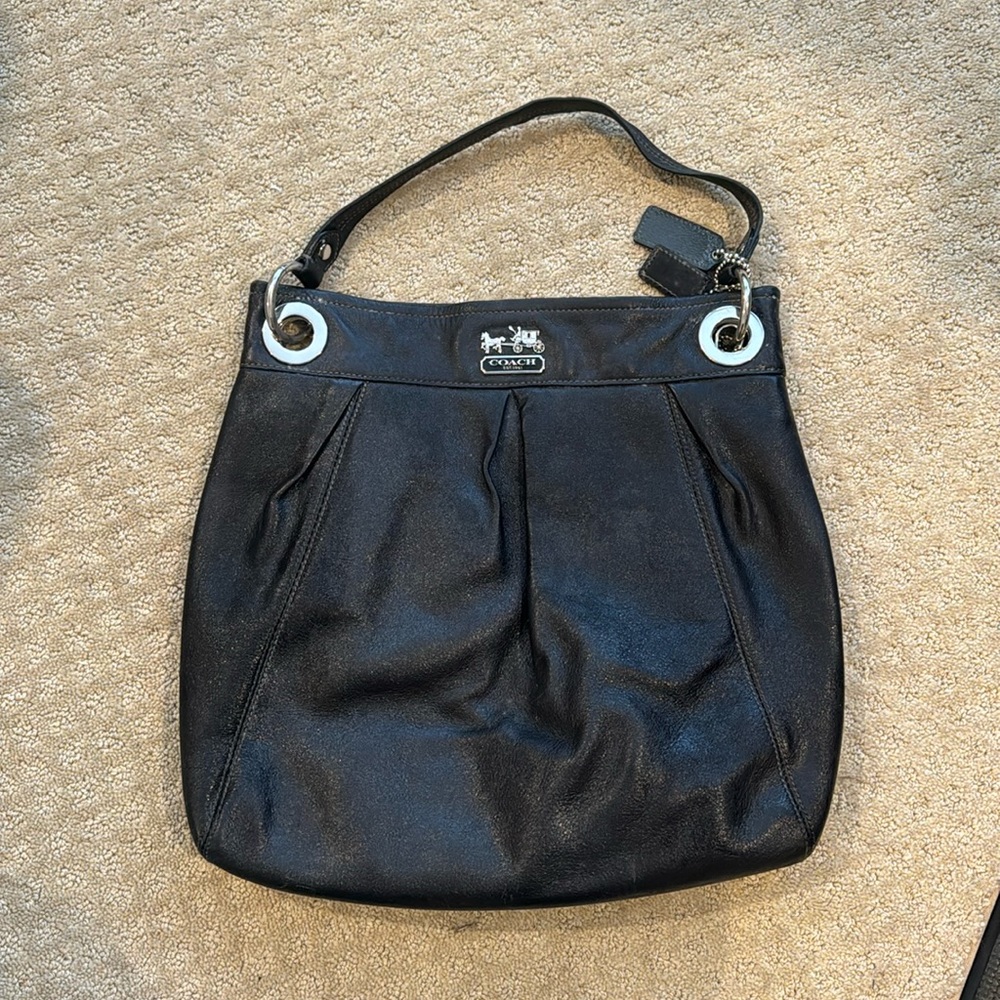 Black leather coach bag. Great condition. Purple silk interior. Magnetic button